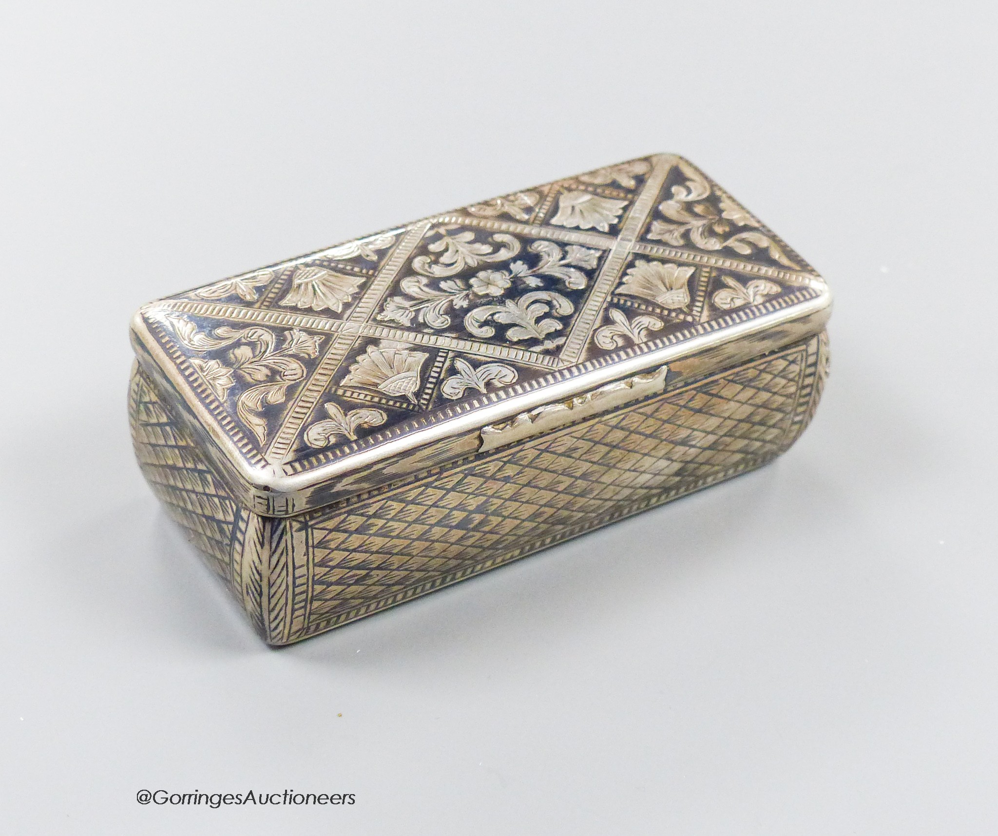 A 19th century Russian 84 zolotnik and niello rectangular snuff box, with trellis and scroll decoration, 87mm, (date rubbed), 107 grams.
